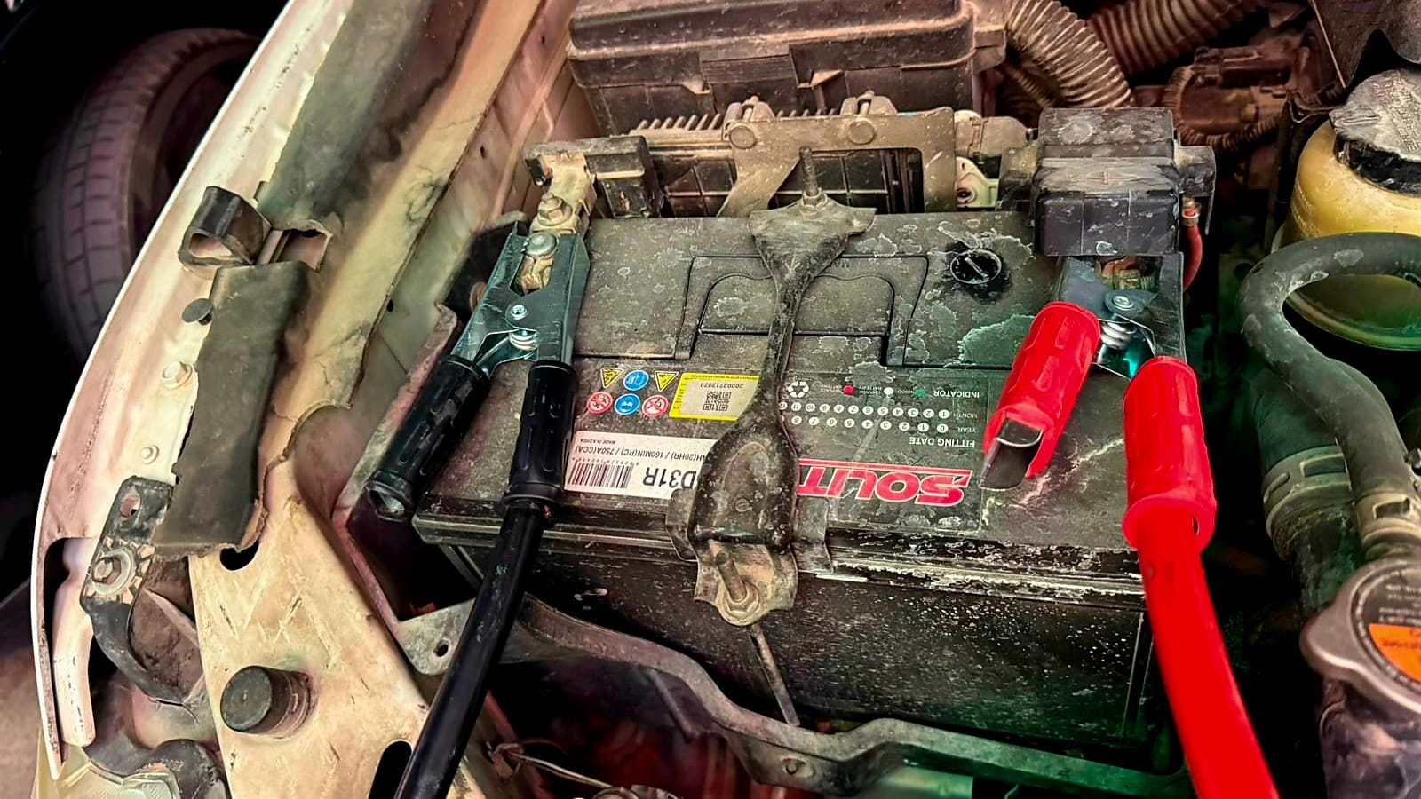 Mobile car battery jump start technician assisting a customer in Dubai